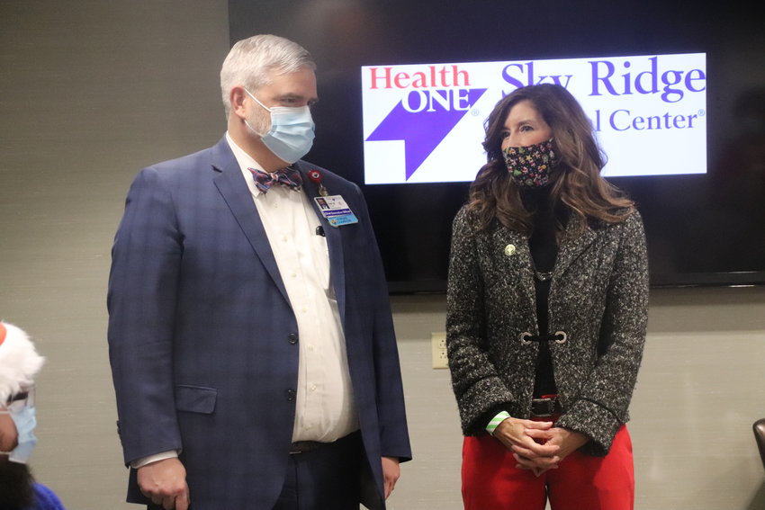 Sky Ridge Medical Center CEO Kirk McCarty, left, and Lone Tree Mayor Jackie Millet speak prior to the hospital administering the first shots of COVID-19 Dec. 16.